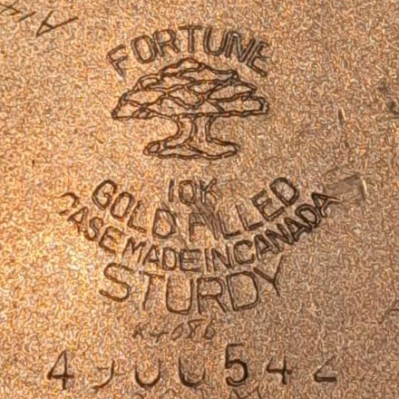 Watch Case Marking for American Watch Case Co. of Toronto, Ltd. Fortune Sturdy: Fortune
[Tree]
10K
Gold Filled
Case Made In Canada
Sturdy